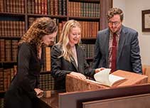 staff in new york gallery looking at book