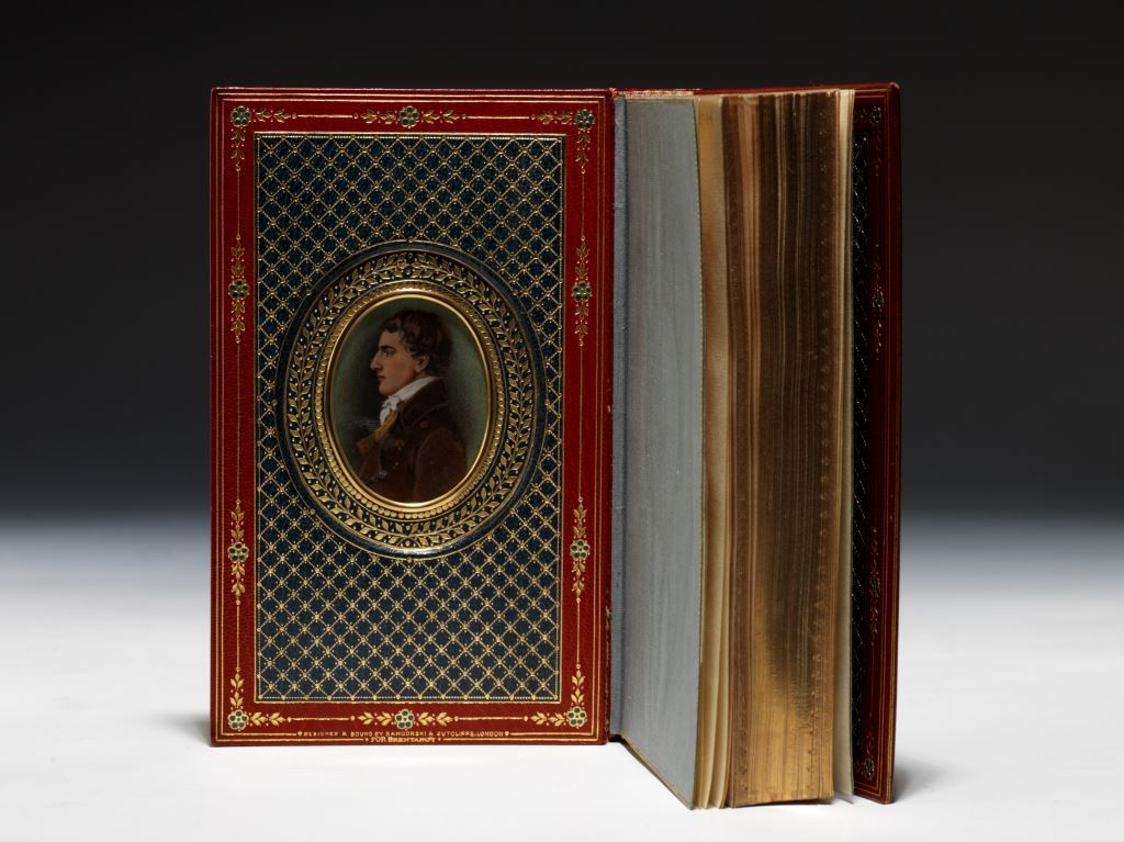 The first collection in book form of Charles Lamb’s Elia essays, beautifully bound by Sangorski & Sutcliffe in an exquisite full red morocco Cosway-style binding, inset on the front doublure with a wonderful watercolor portrait of Lamb (BRB 80867)