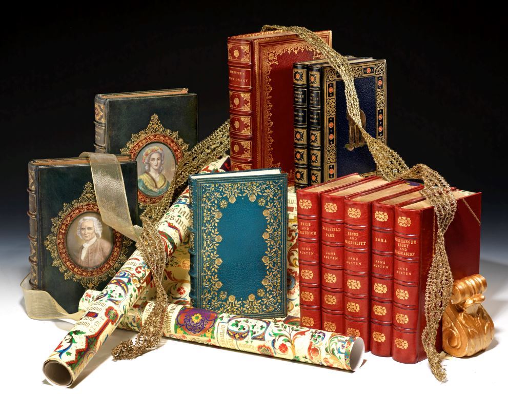 selection of rare books with ribbons and wrapping paper
